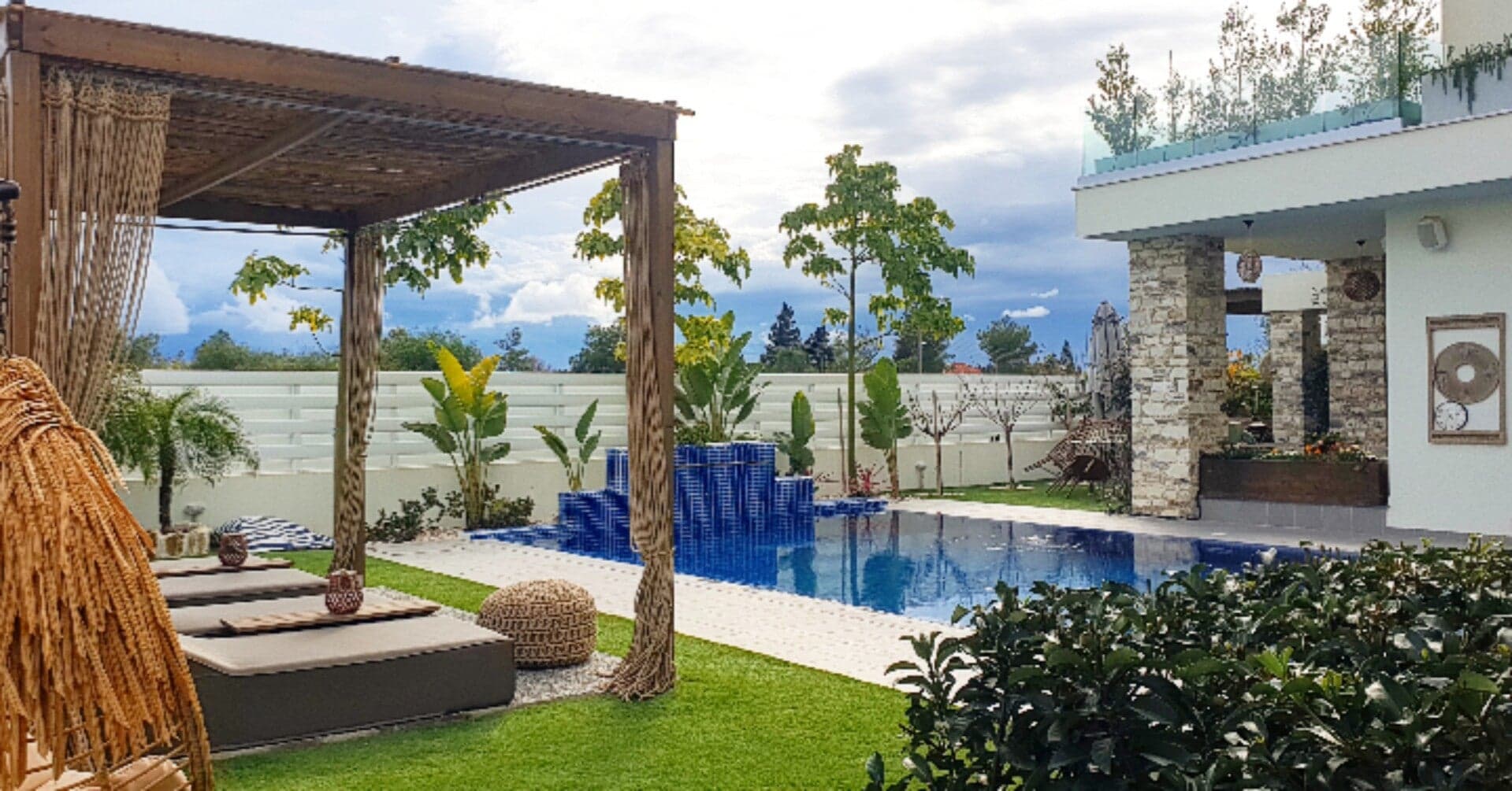 Outdoor living space with lush Mediterranean vegetation designed by Green Planet Gardening